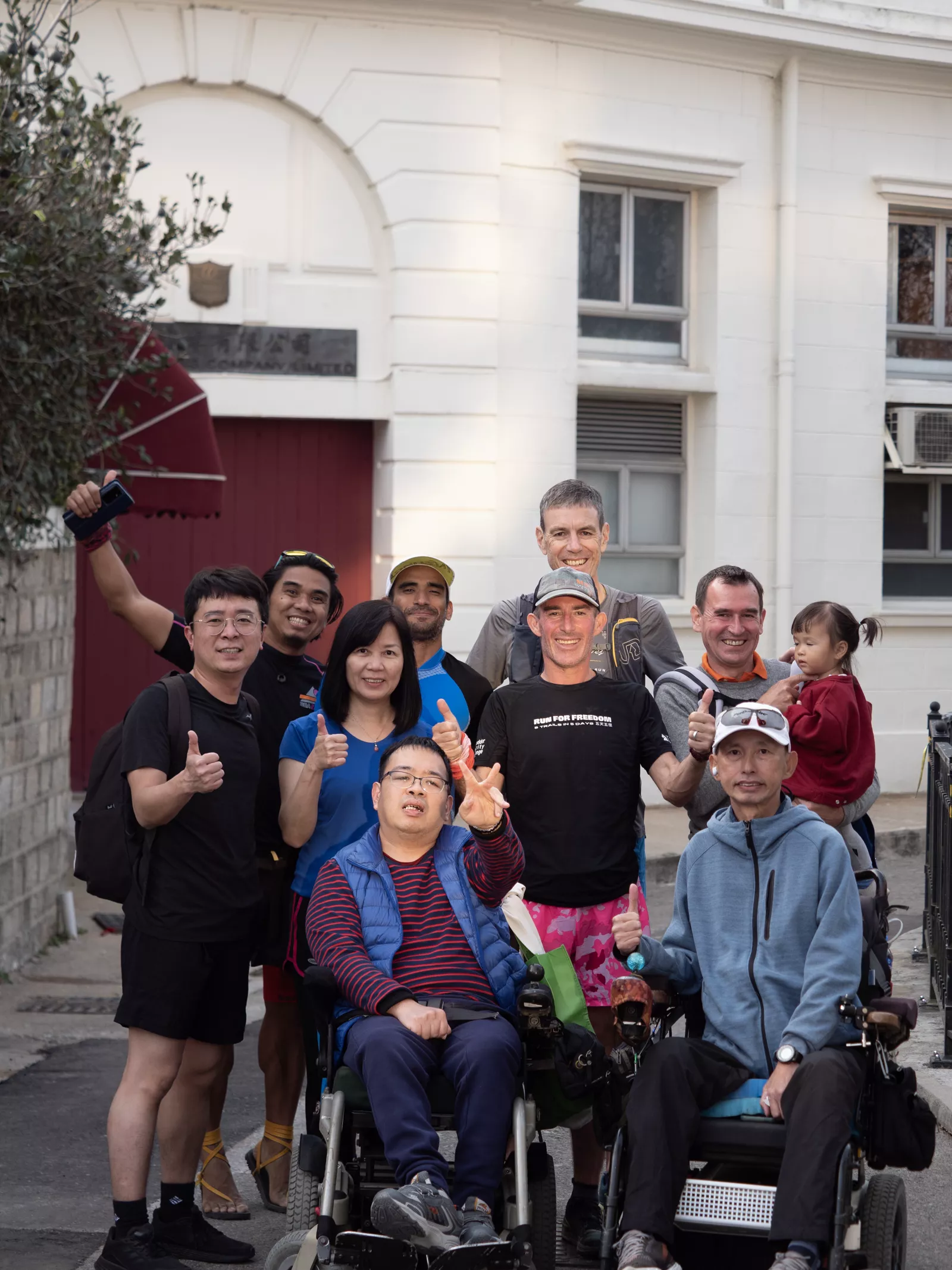 Jo Lodder celebrating with teammates in wheelchairs and supporters after the challenge