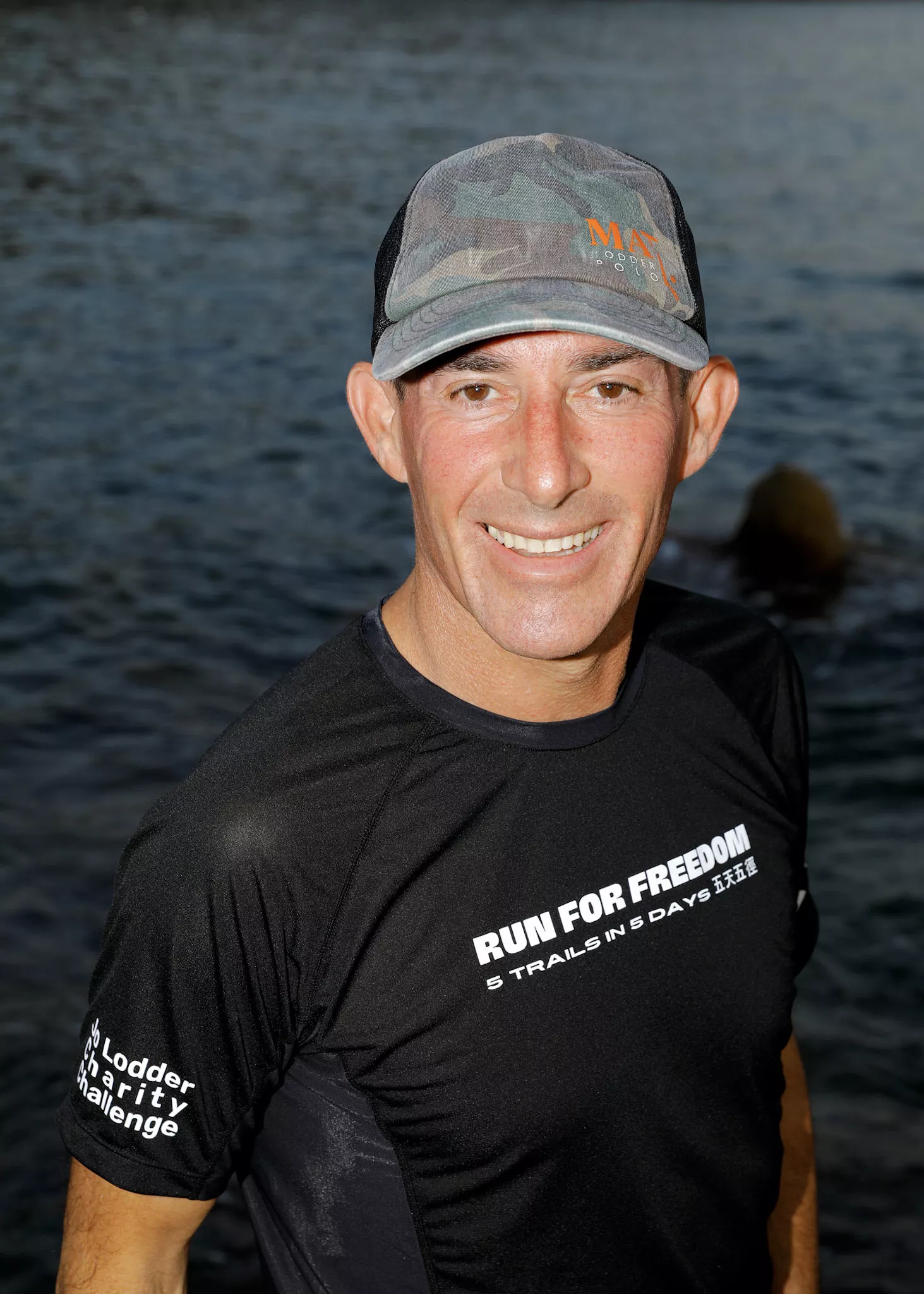 Jo Lodder smiling in his Run for Freedom — 5 Trails in 5 Days race top